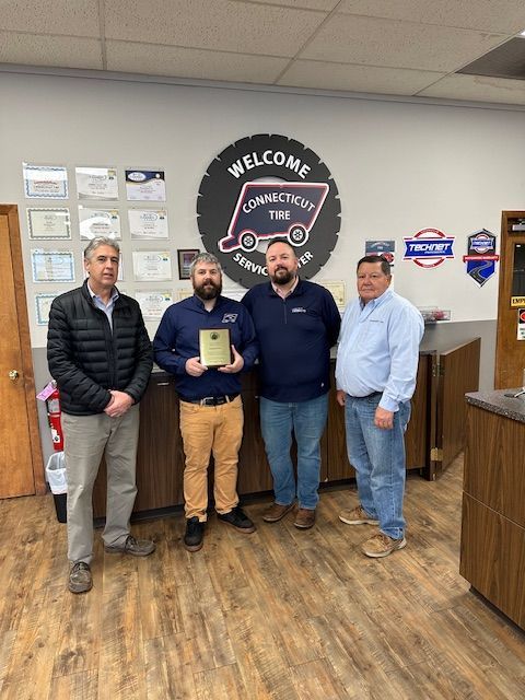 Connecticut tire receiving award.