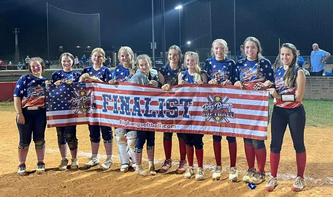 A group of women standing next to each other holding an american flag.