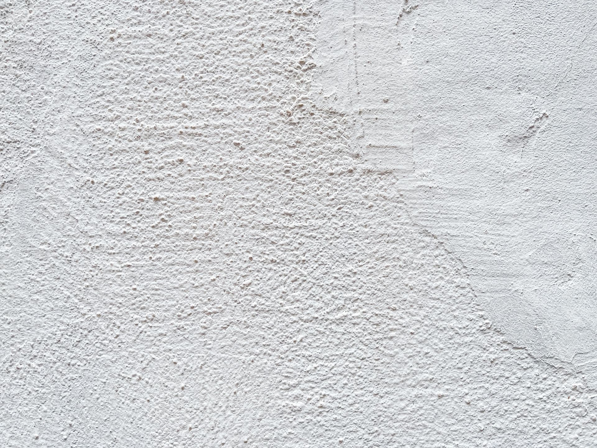 A close up of a white concrete wall texture.