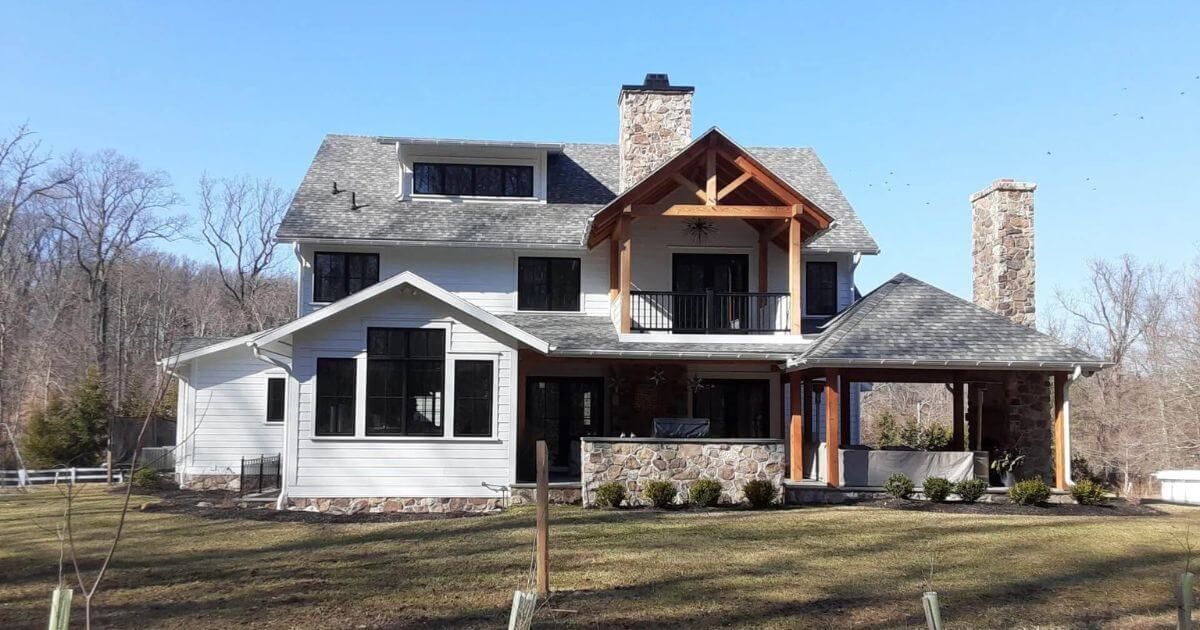 A woman is working on a roof with a drill.