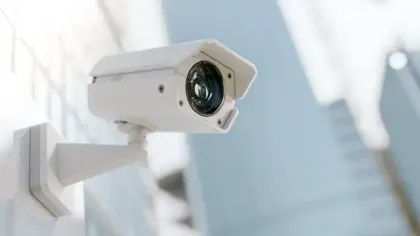 A security camera is mounted on a wall in a room.