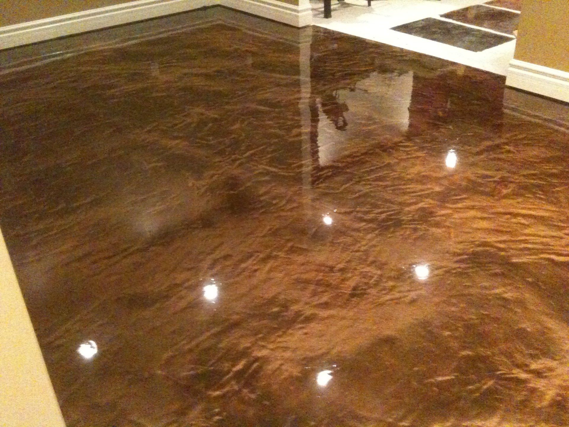 A brown metallic floor with a reflection of lights on it