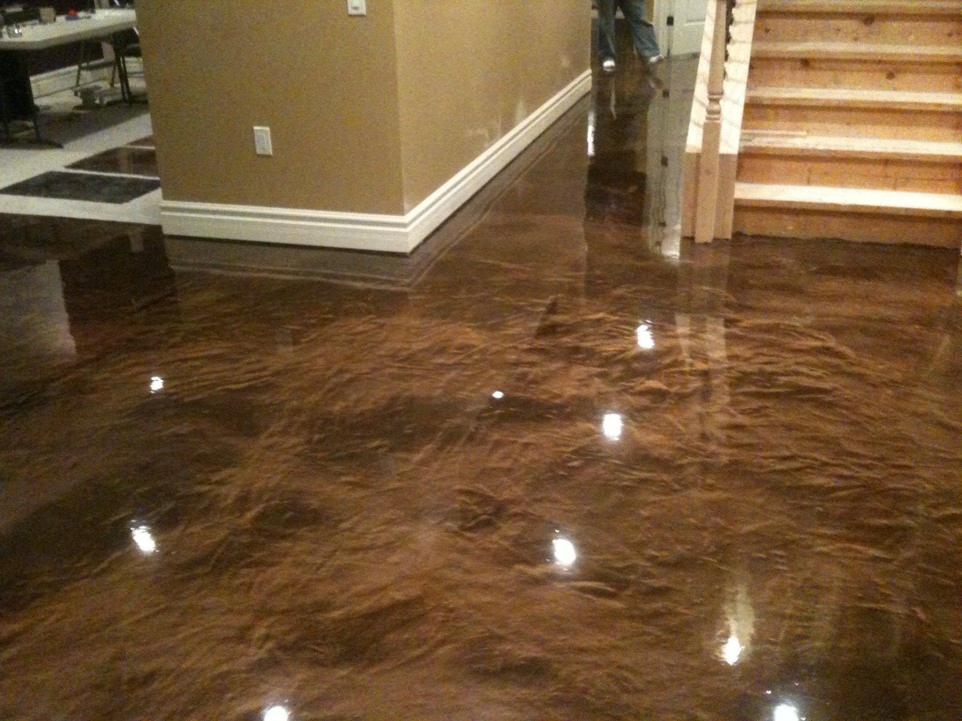 A shiny brown floor with stairs in the background