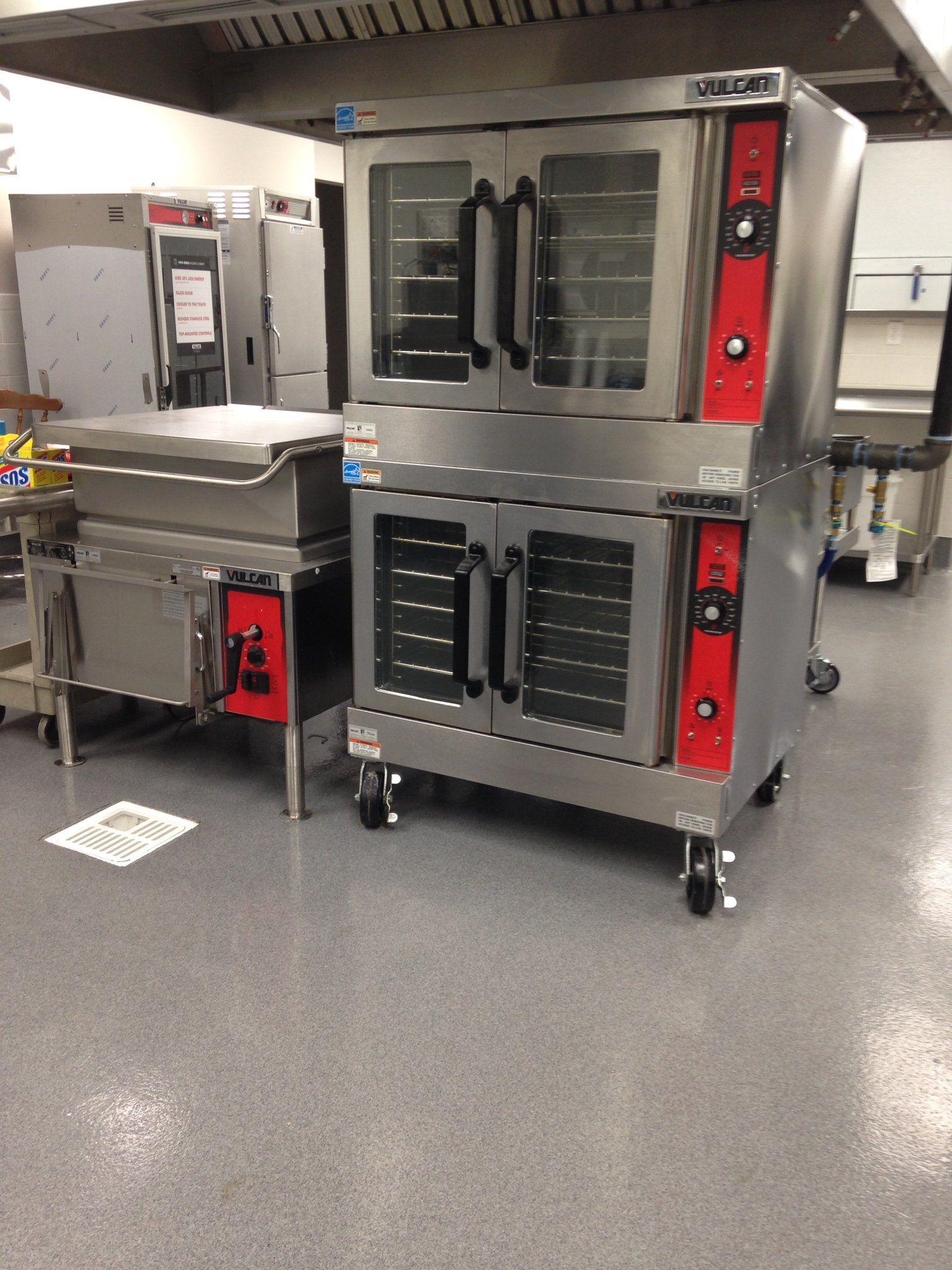 Two ovens are stacked on top of each other in a kitchen