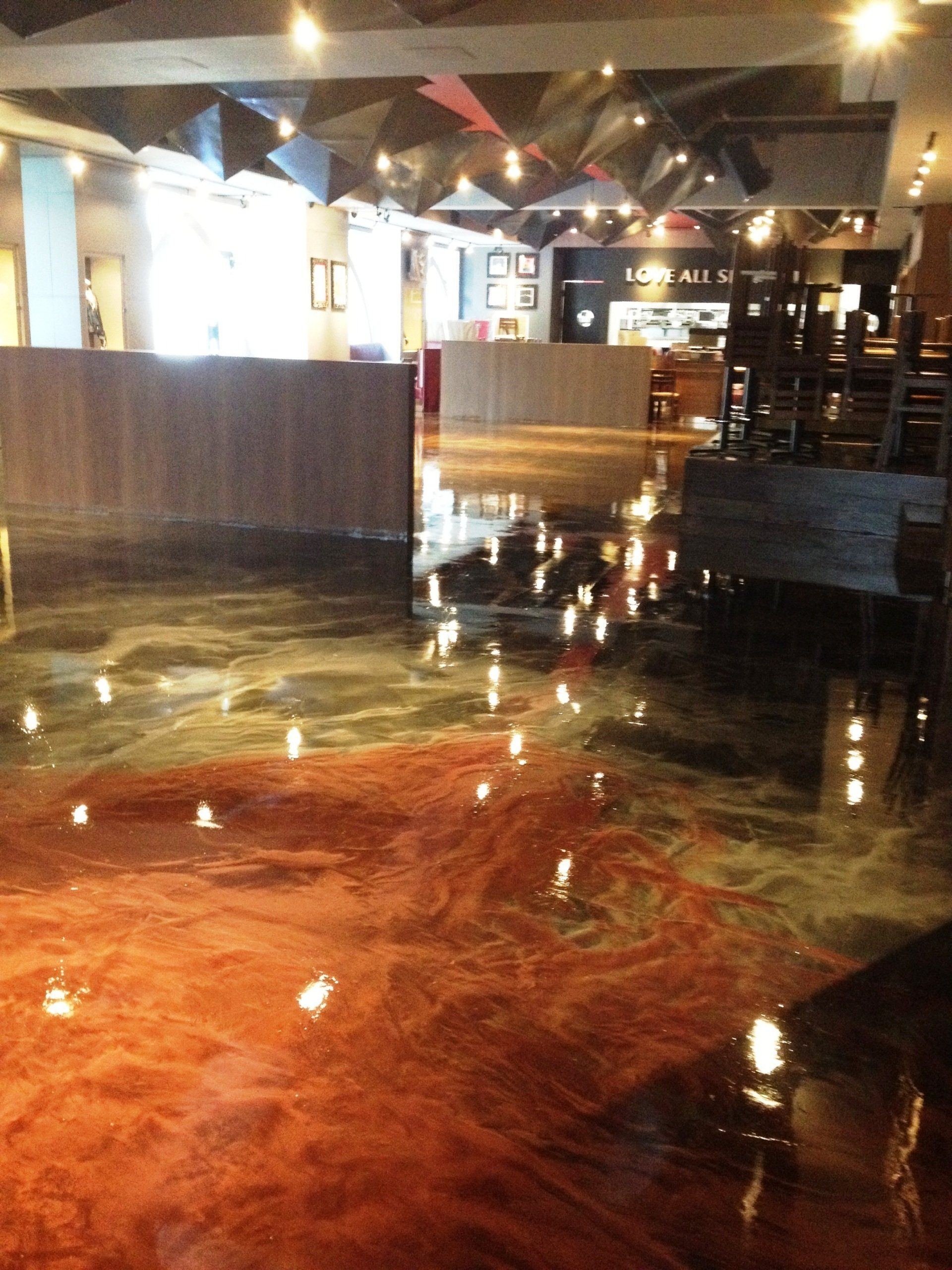 A large room with a shiny floor and a sign that says ' a ' on it