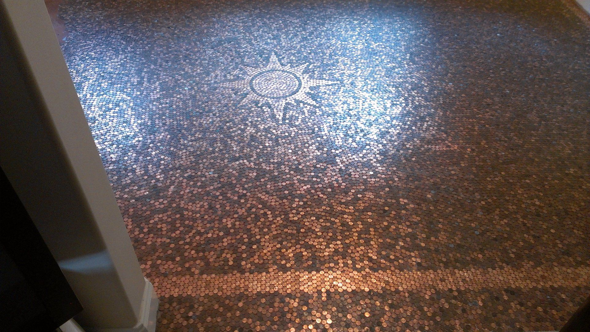 A close up of a shiny floor in a room.