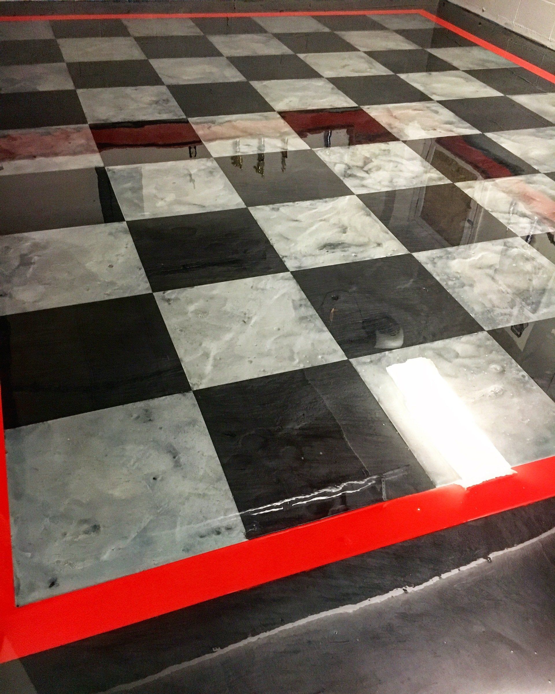 A black and white checkered floor with a red border