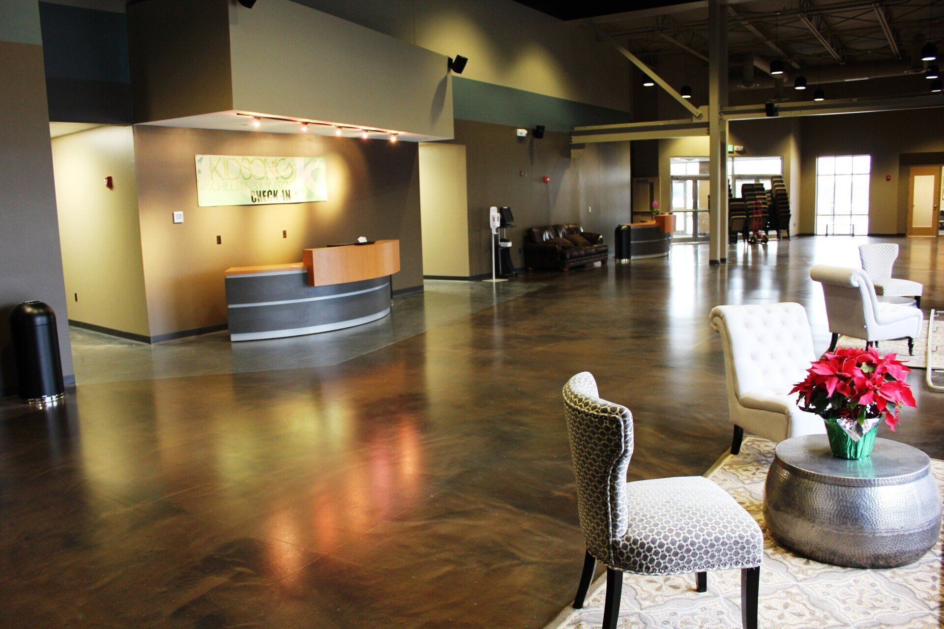 A large lobby with a reception desk and chairs