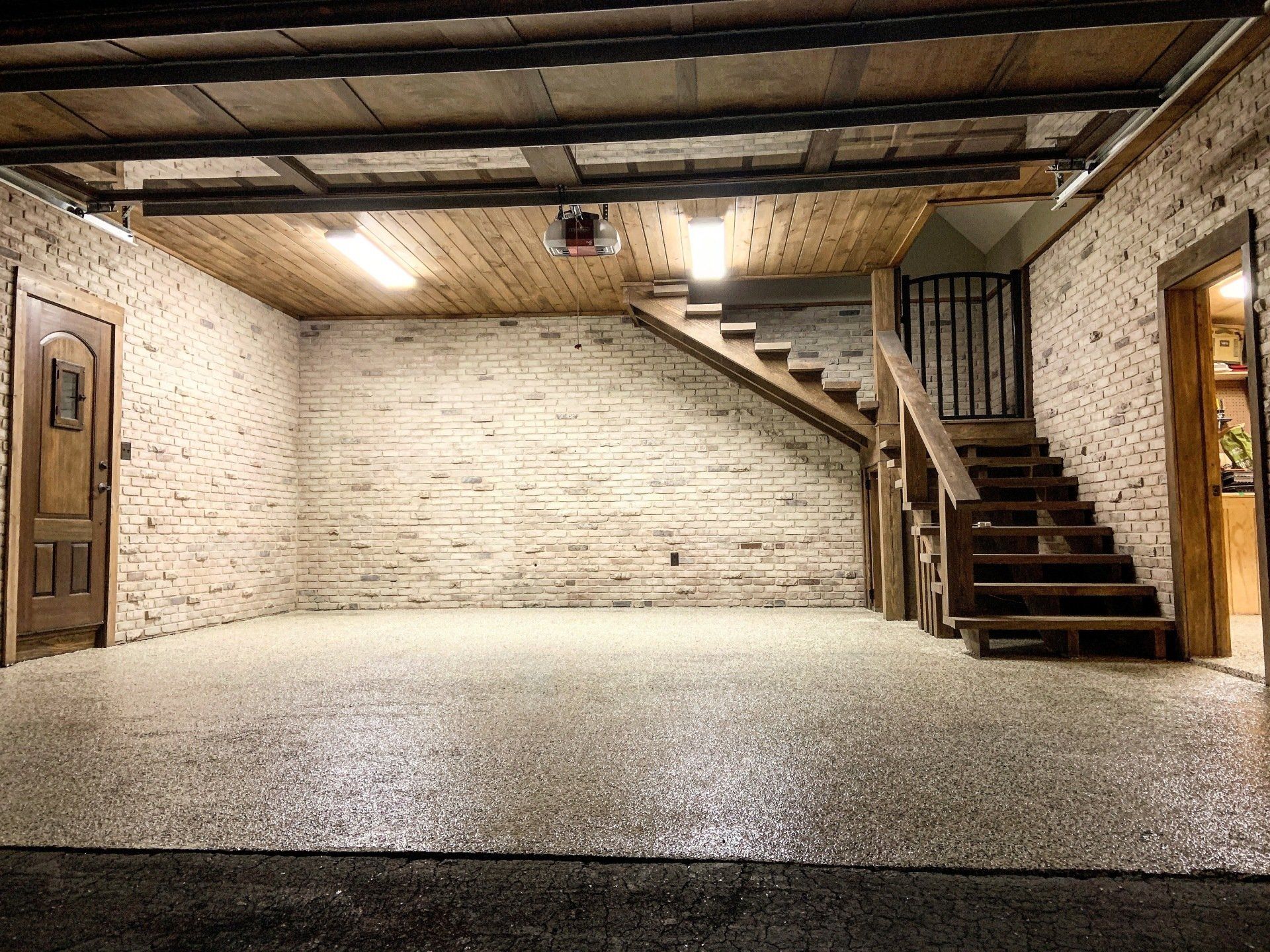 A garage with stairs leading up to the second floor.