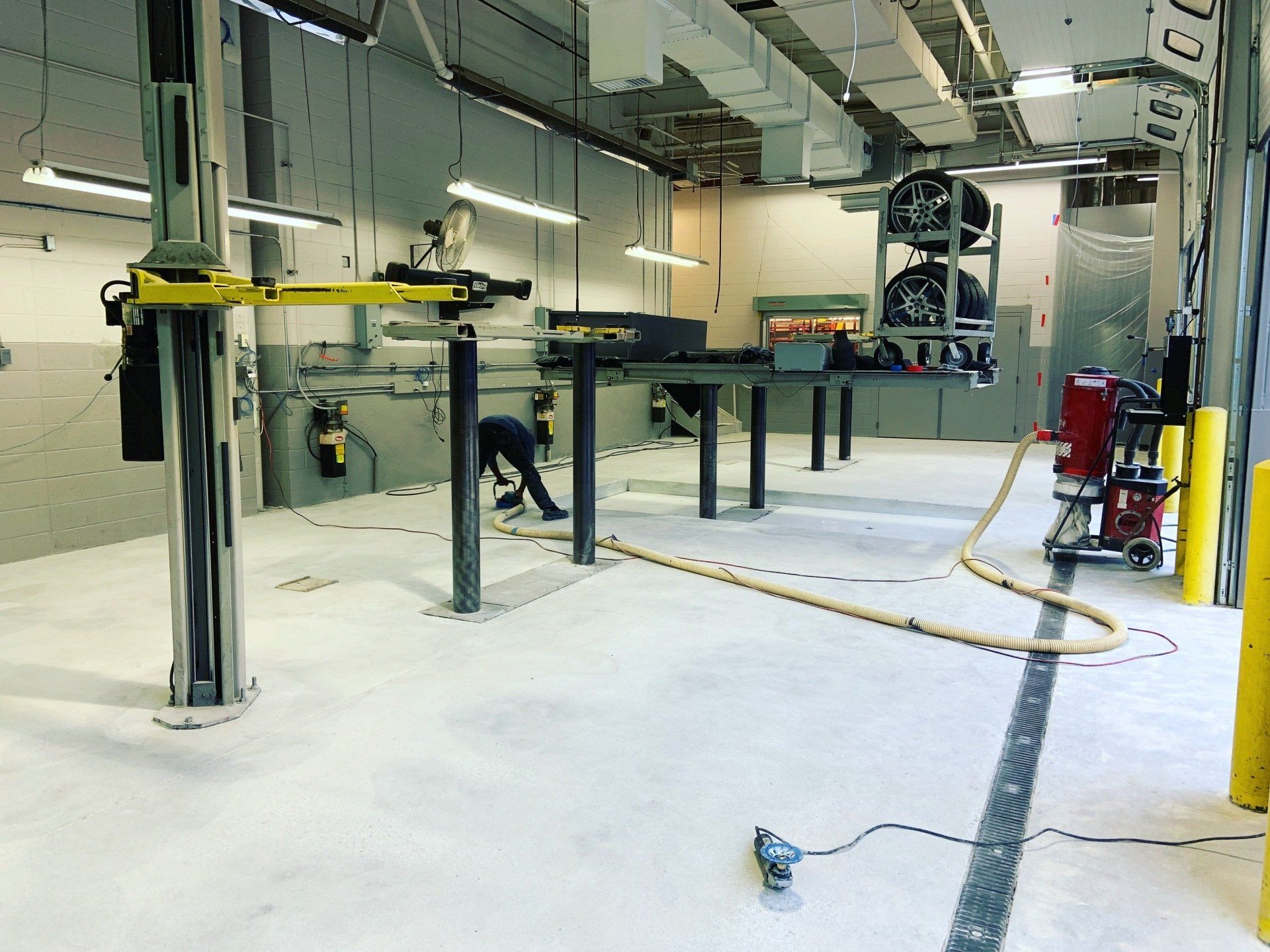 A man is working on a machine in a garage