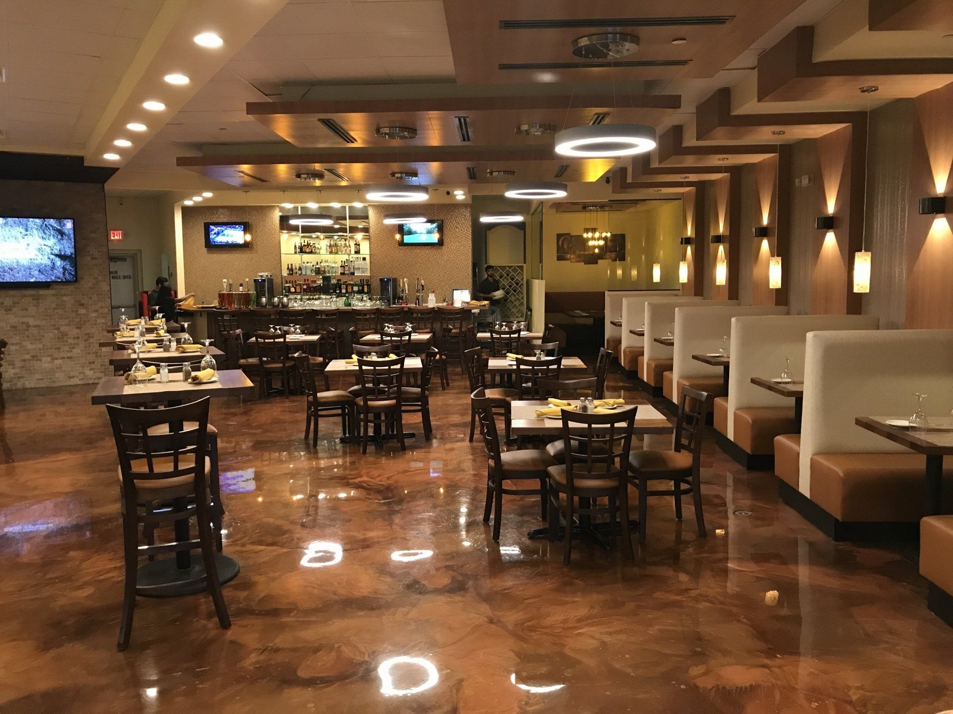 A restaurant with tables and chairs and a bar