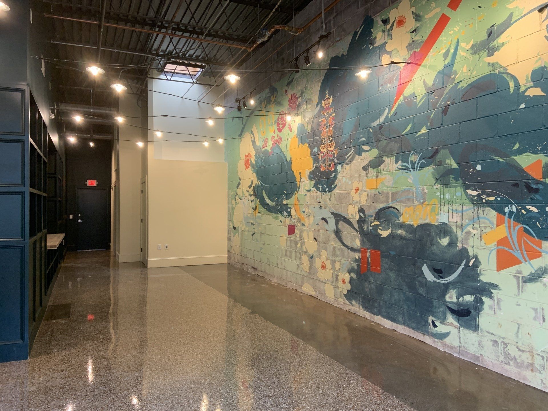 An empty hallway with a large mural on the wall.