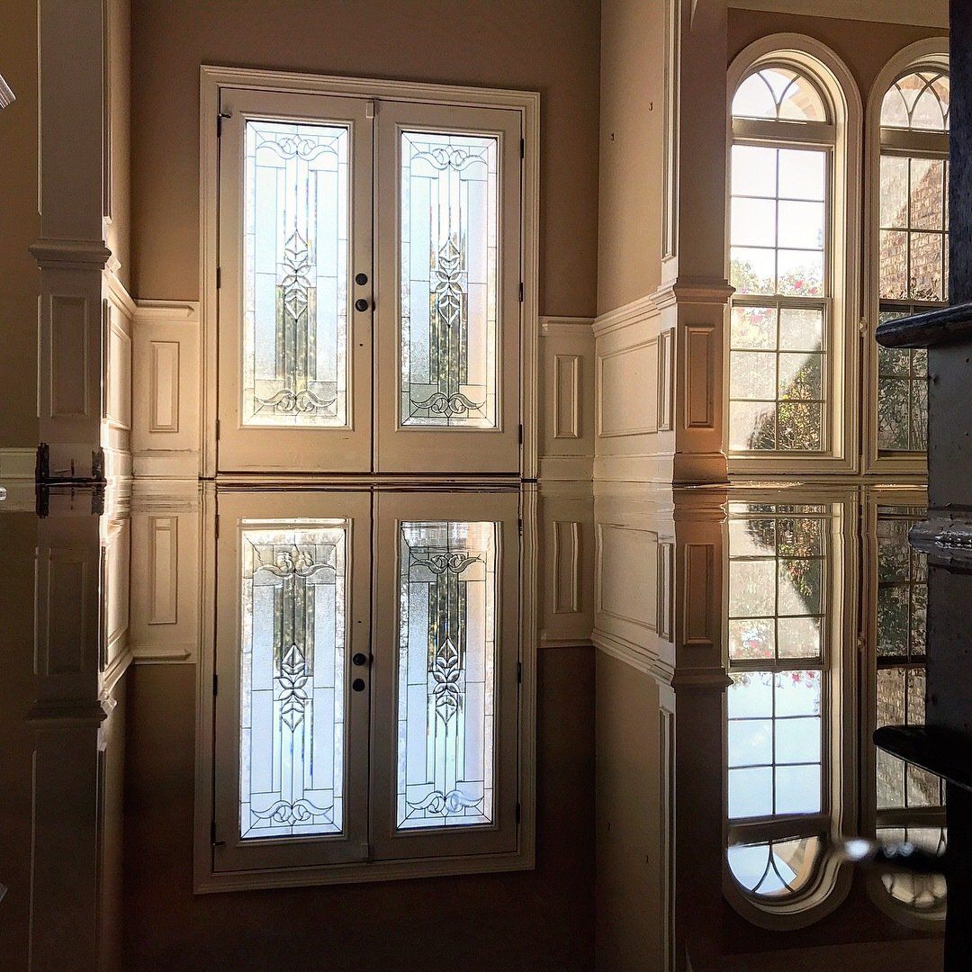 A room with a lot of windows and a mirrored floor