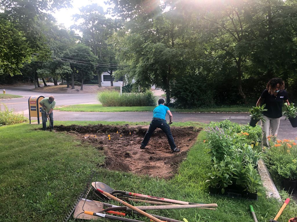 Preparing the planting bed, avoiding in ground lines not to be touched, marked by flags. Always call 811 before digging.
