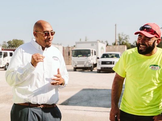 Manager in the field speaking with employees.