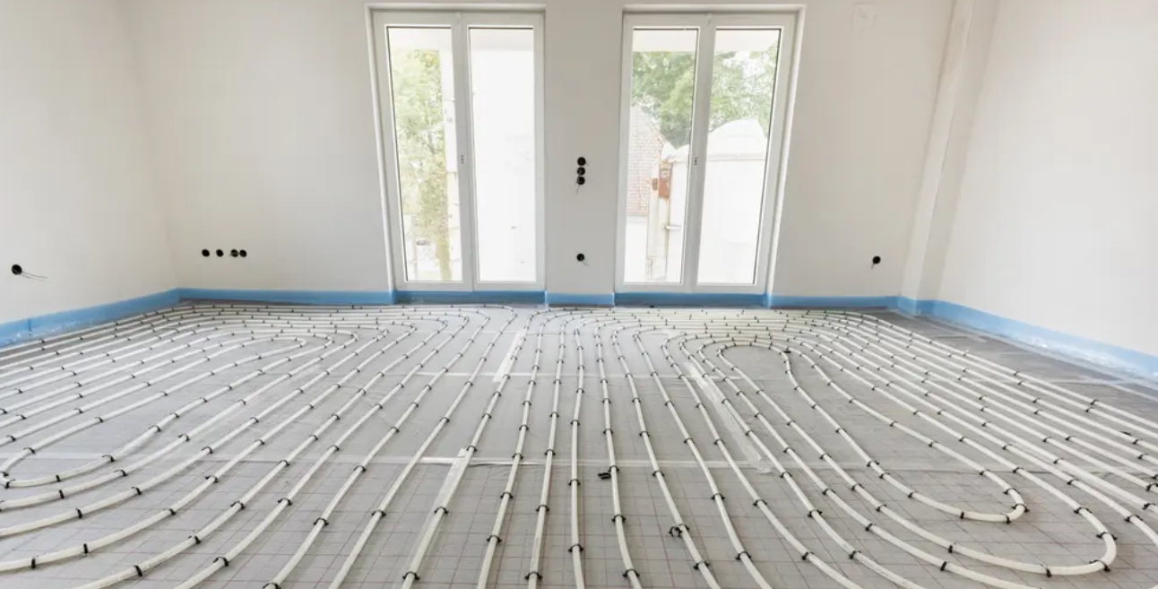 A room with a heating system on the floor.