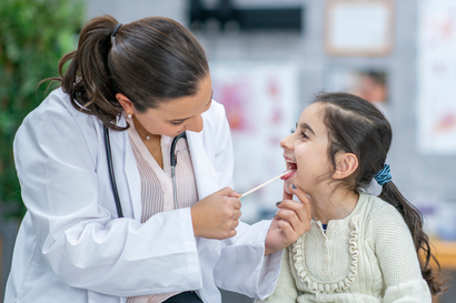 dentist is checking girl's mouth