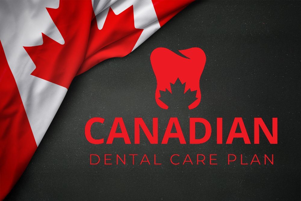 A man is sitting in a dental chair giving a thumbs up.