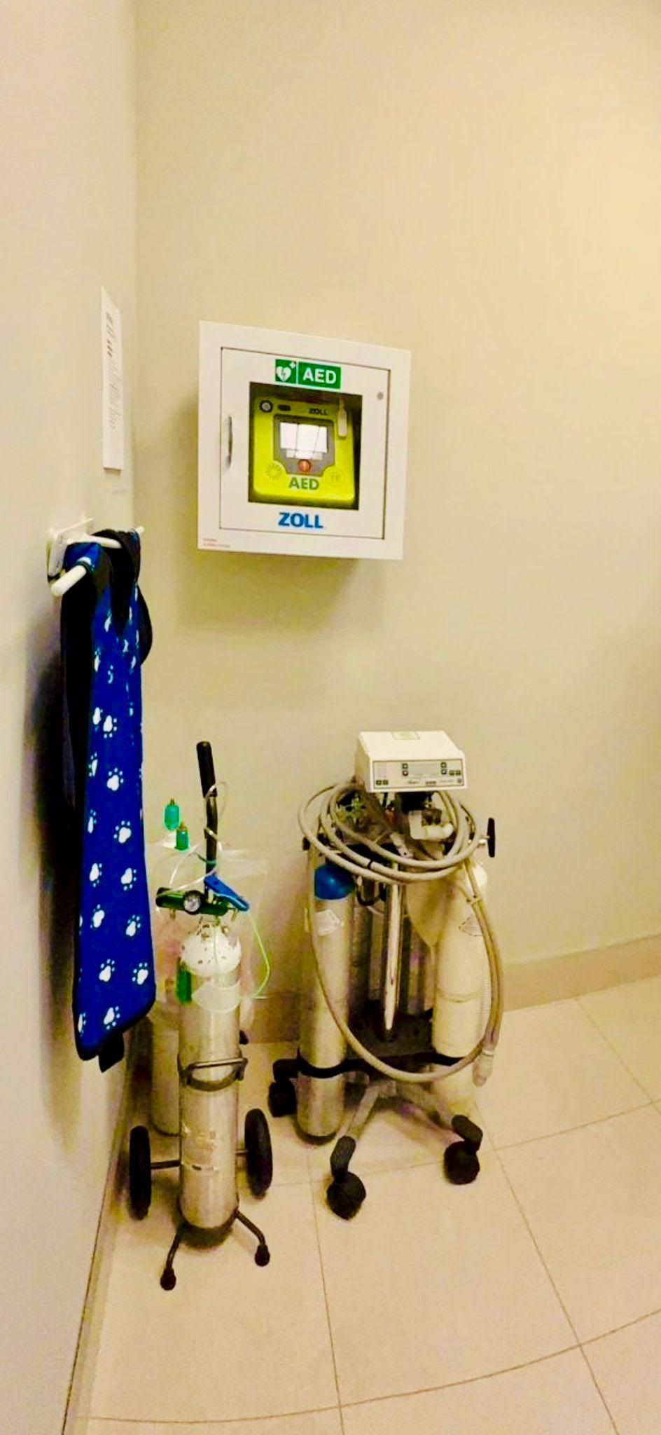 A room with a lot of oxygen cylinders and a monitor on the wall.