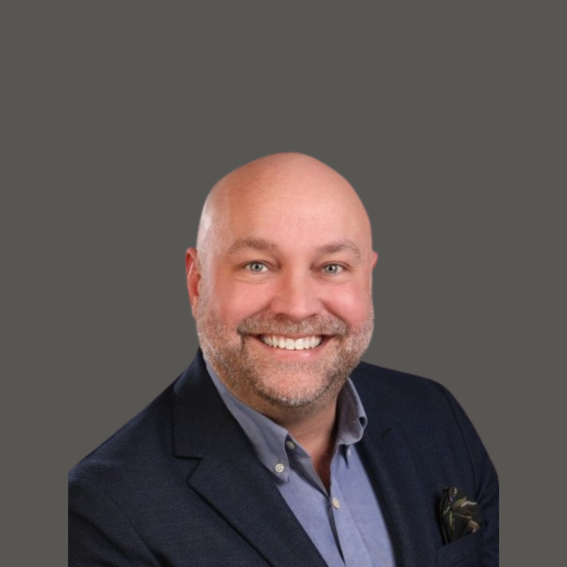 A bald man with a beard wearing a suit and smiling