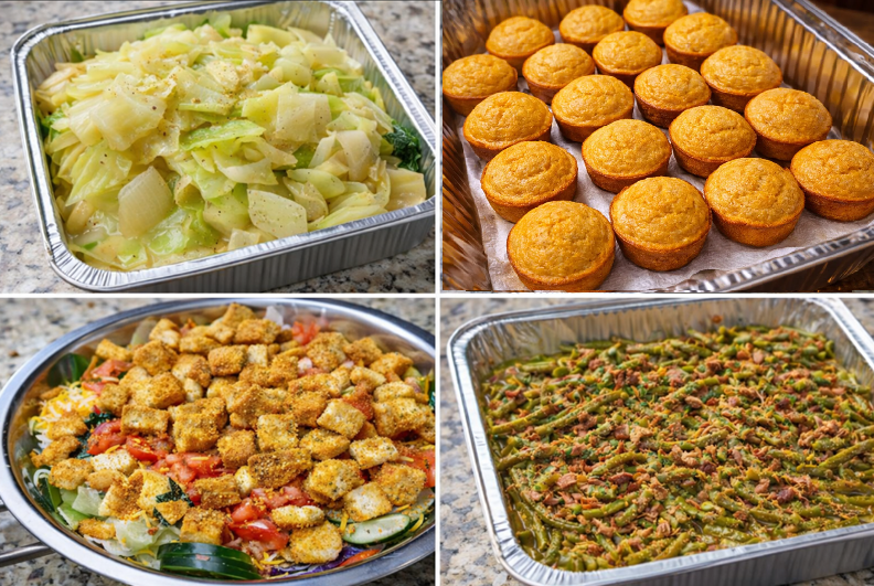 Aluminum trays of prepared food: mac and cheese, green beans, rolls, and a potato salad.