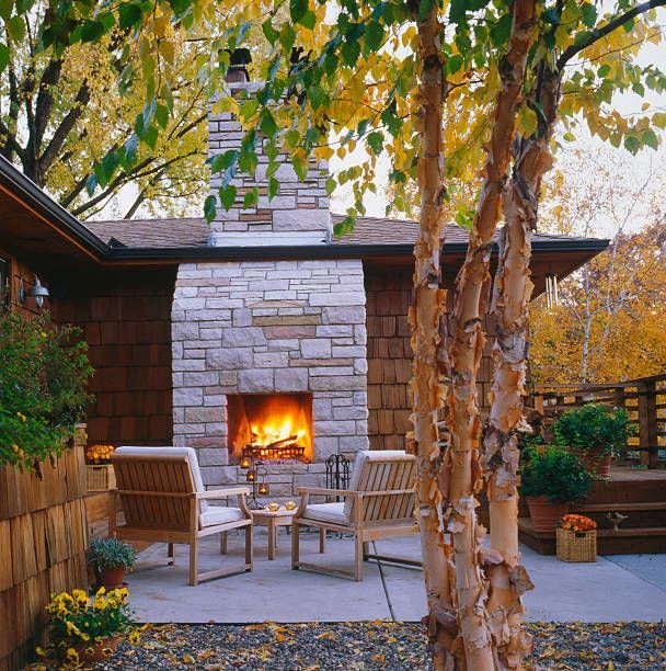 An outdoor fireplace and deck attached to a house finished with cedar shakes – California - Laguna Hills Construction, Inc.