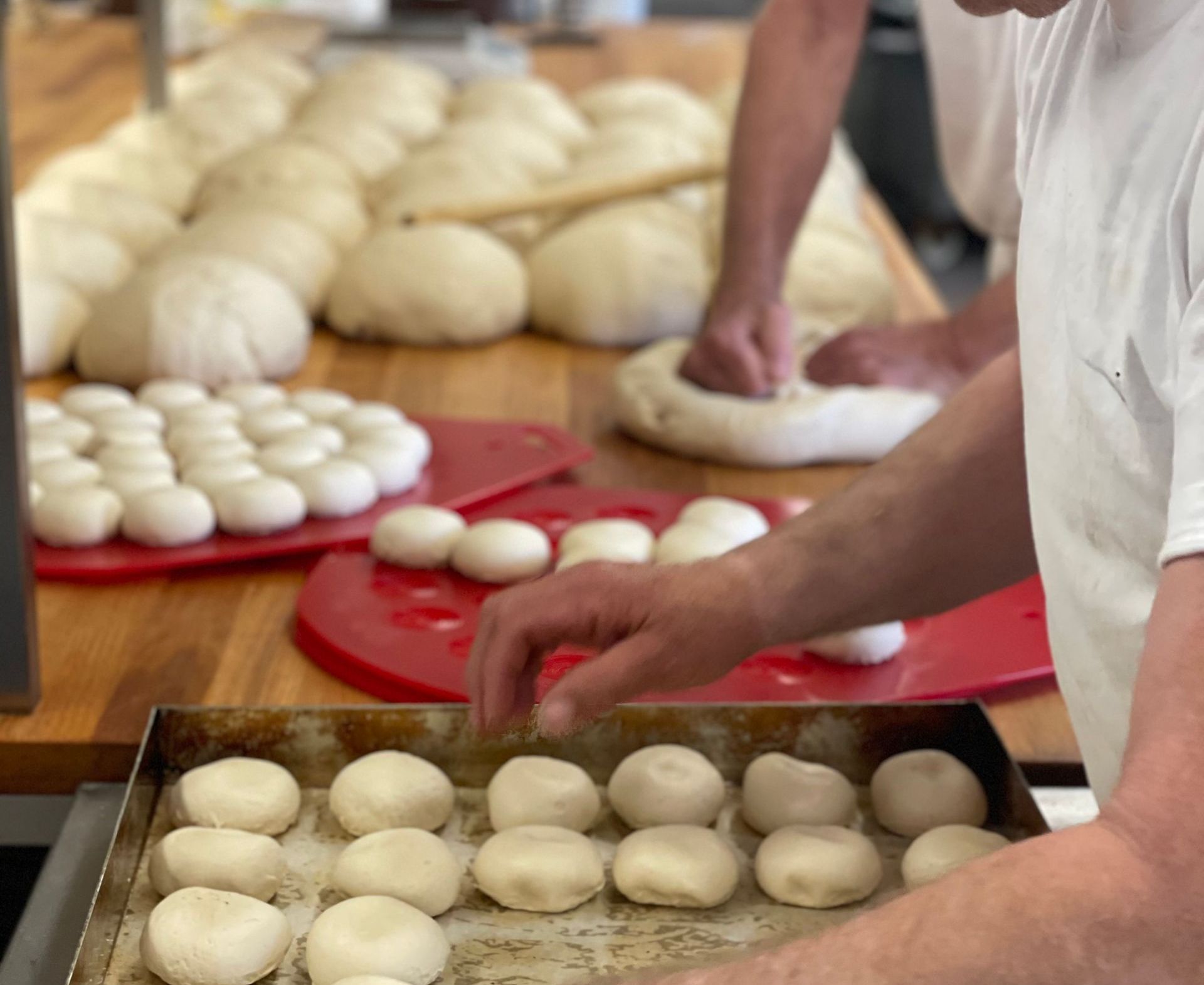 en mand forbereder en masse dej på et bord