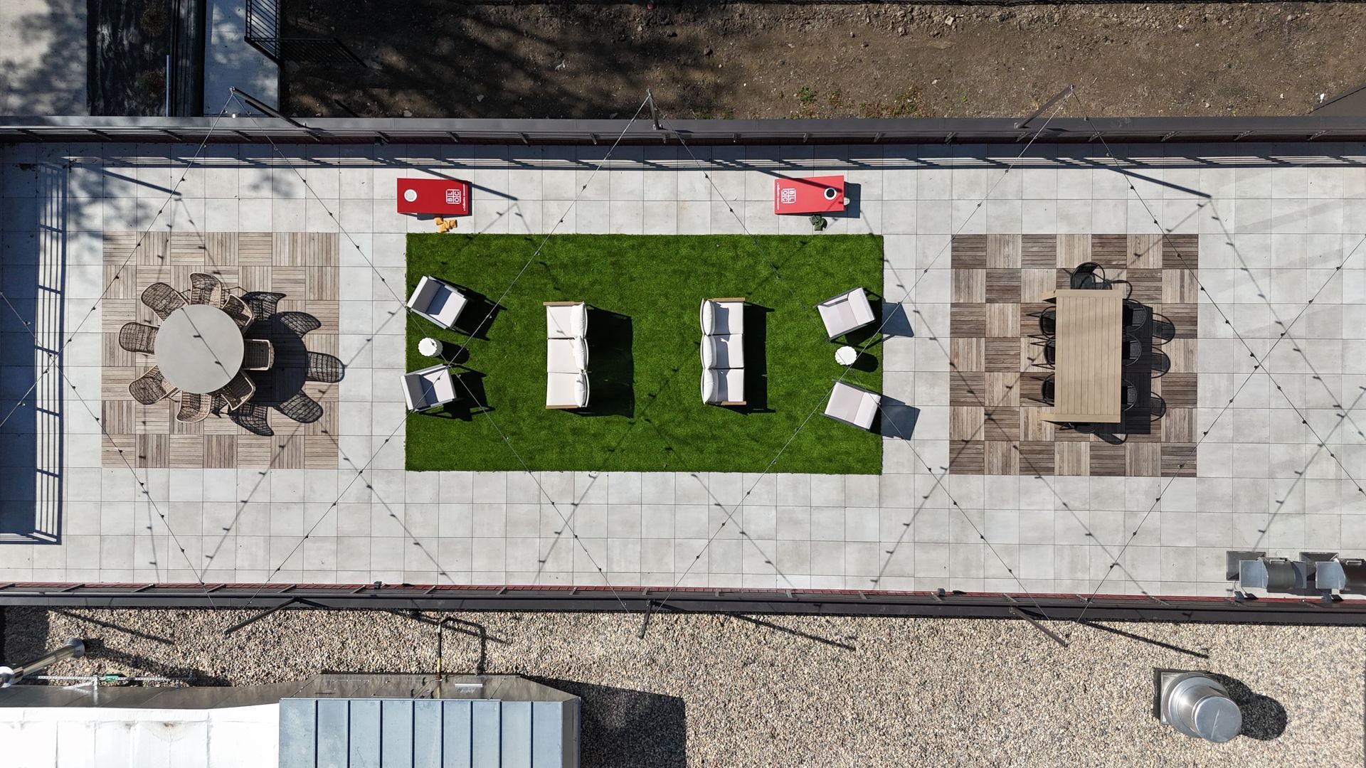 Living room with stone fireplace, wooden accents, TV, black armchair, and red paper lanterns.