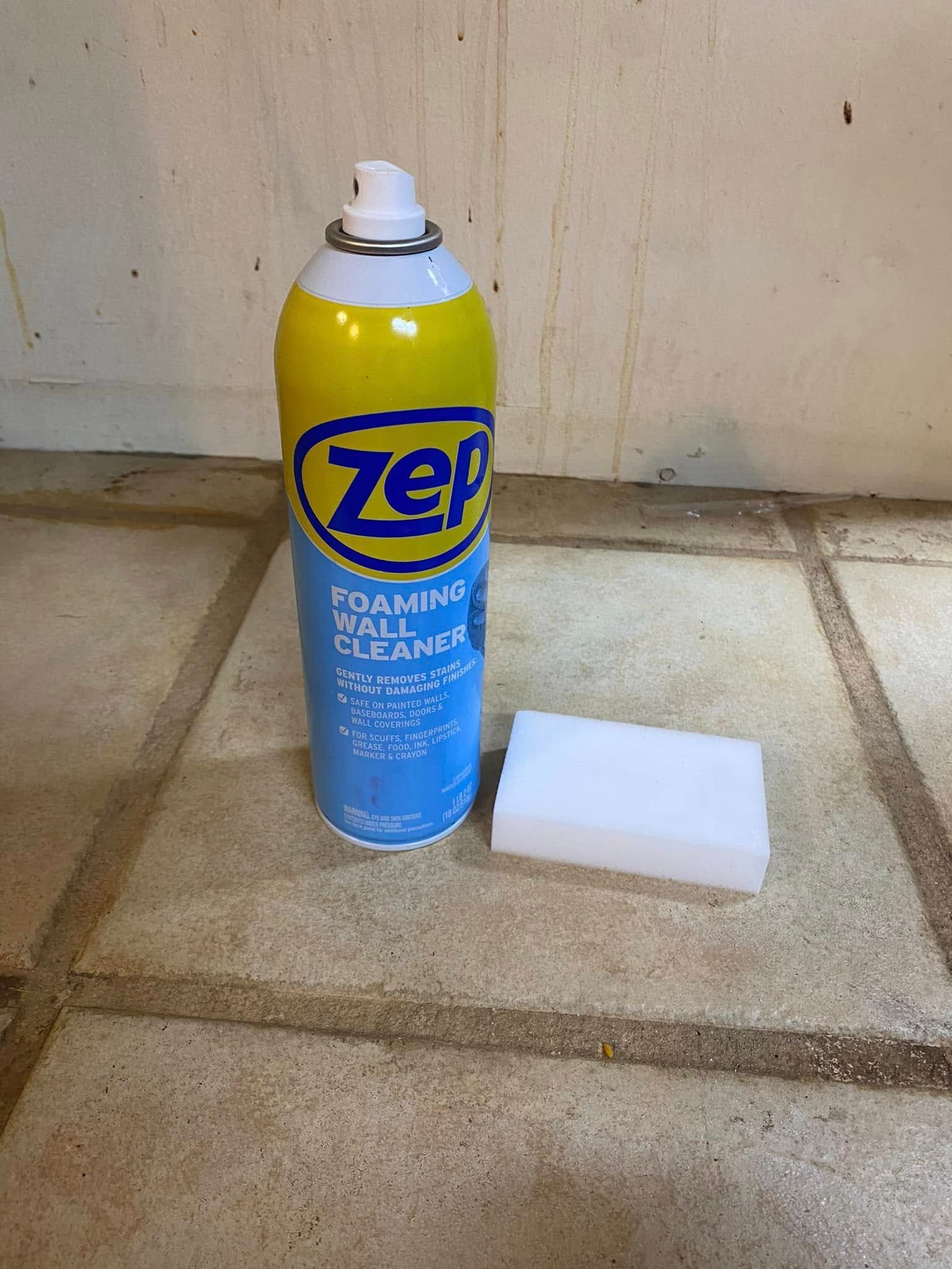 Zep foaming cleaner can beside a white sponge on a tiled floor against a wall