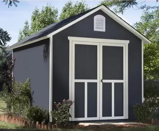 Gray shed with white trim and double doors; set in a yard with greenery.