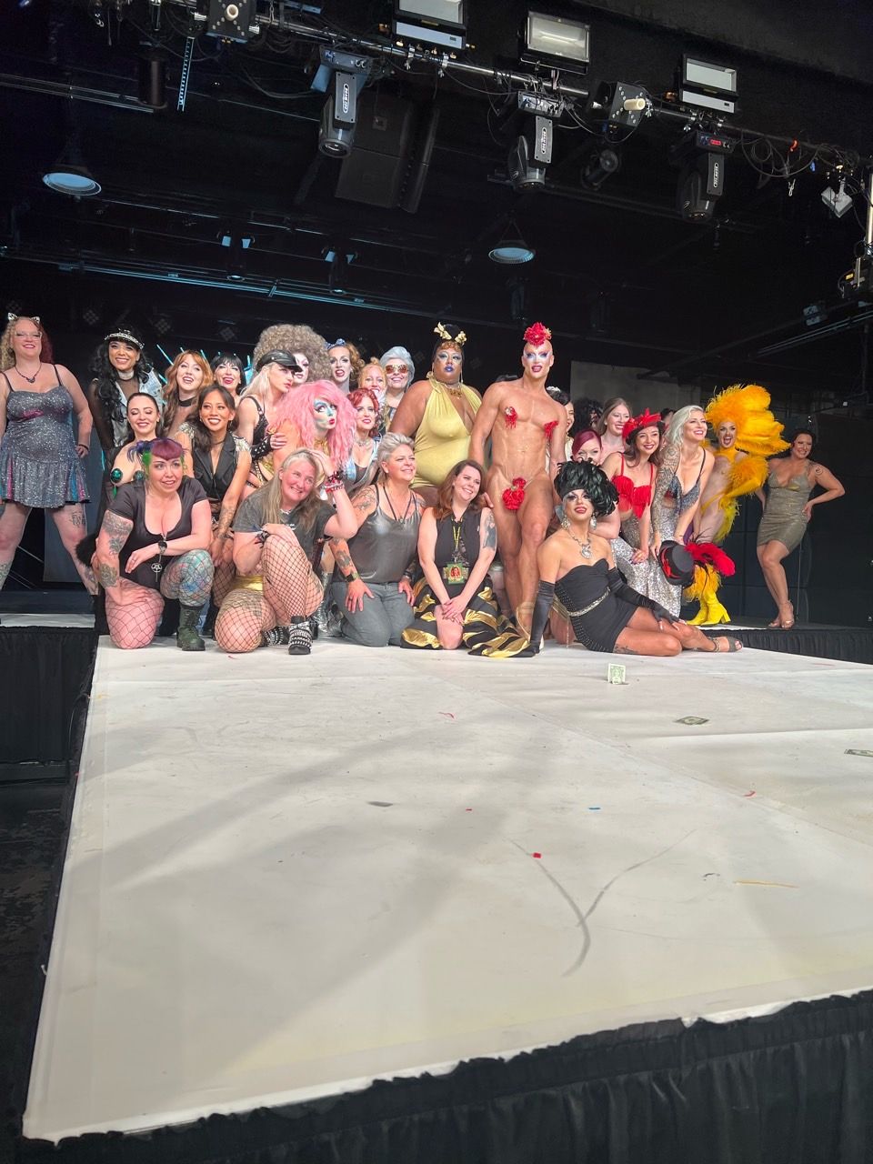 A group of people posing for a picture on a stage