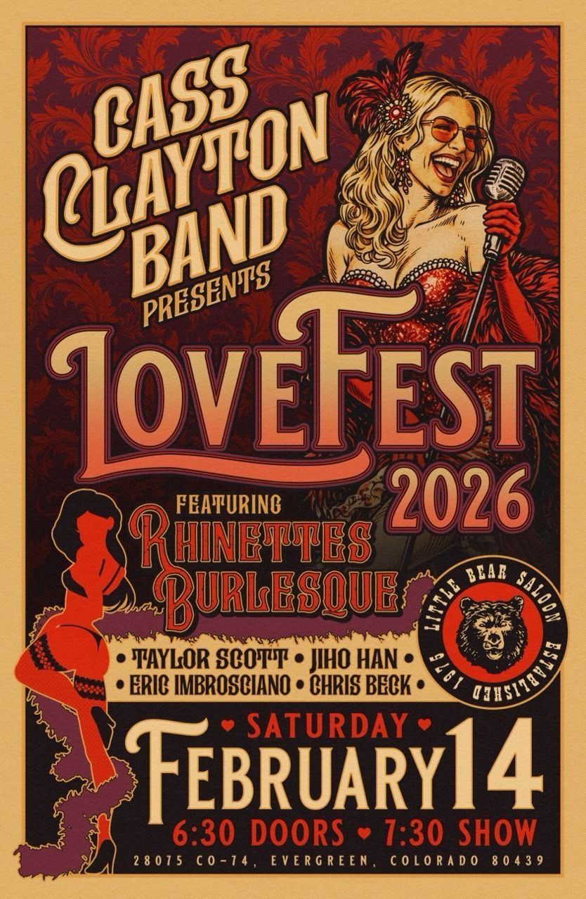 A man in a green suit and top hat is holding a cane.