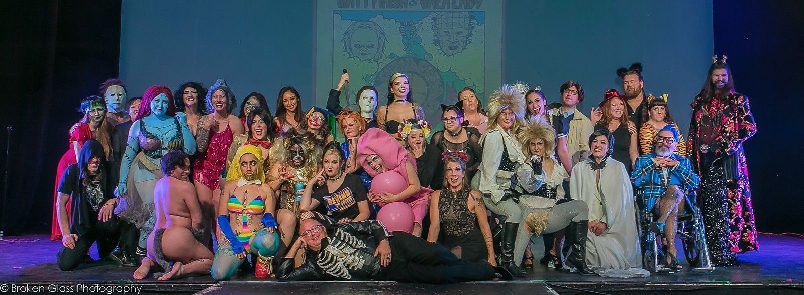 A large group of people are posing for a picture on a stage.