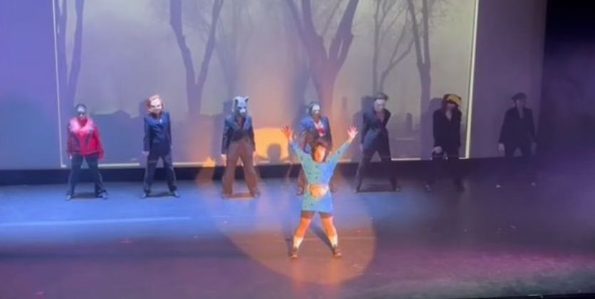 A group of people are dancing on a stage.