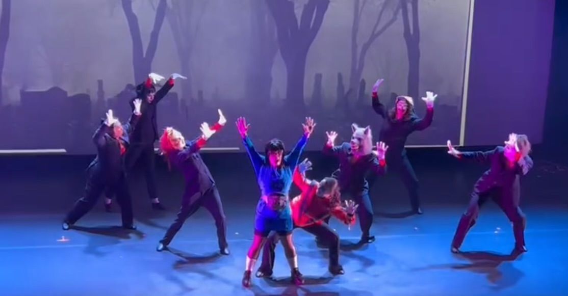 A group of people are dancing on a stage.