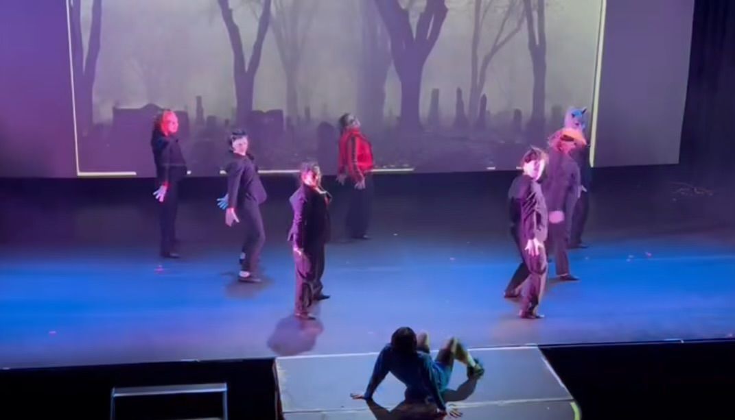 A group of people are dancing on a stage.