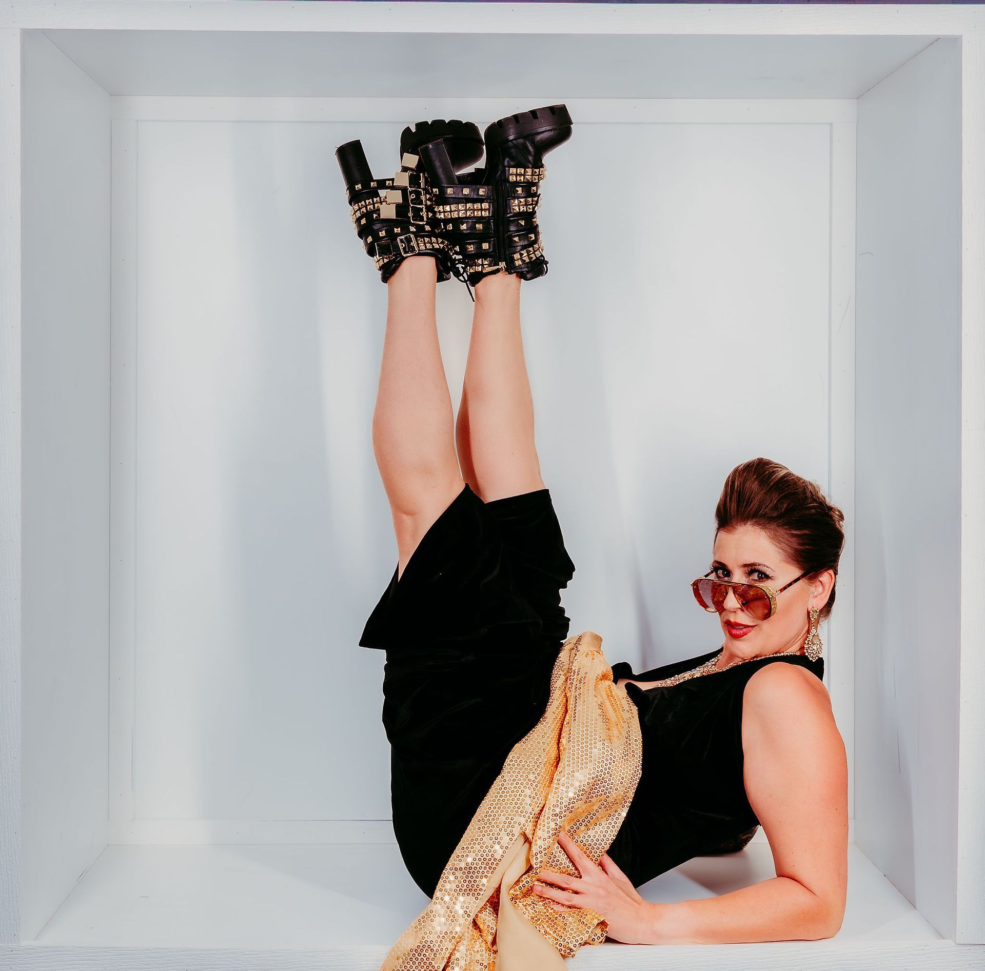 A woman in a purple dress is holding a white cloth