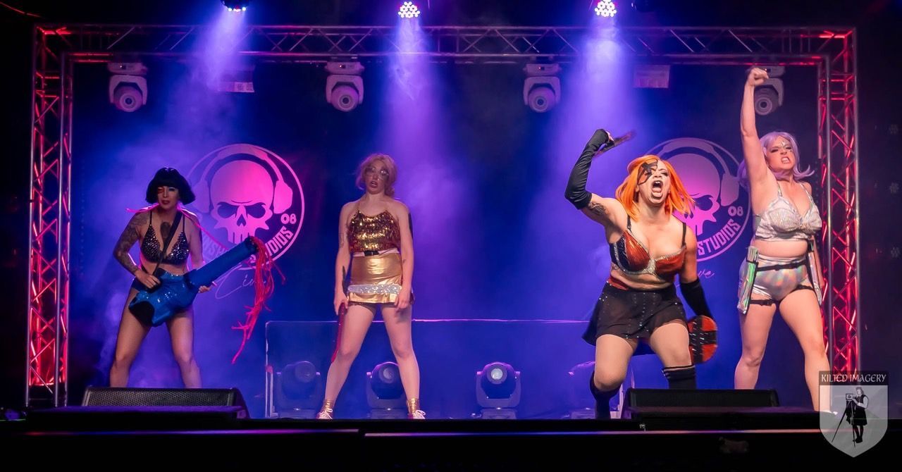 A group of women are standing on a stage.