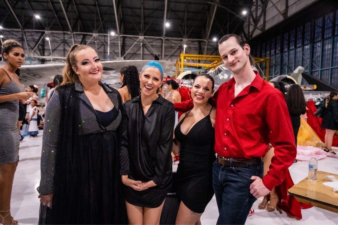 A group of people are posing for a picture on a ice rink.
