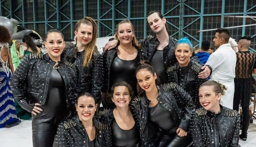 A group of dancers are posing for a picture together.