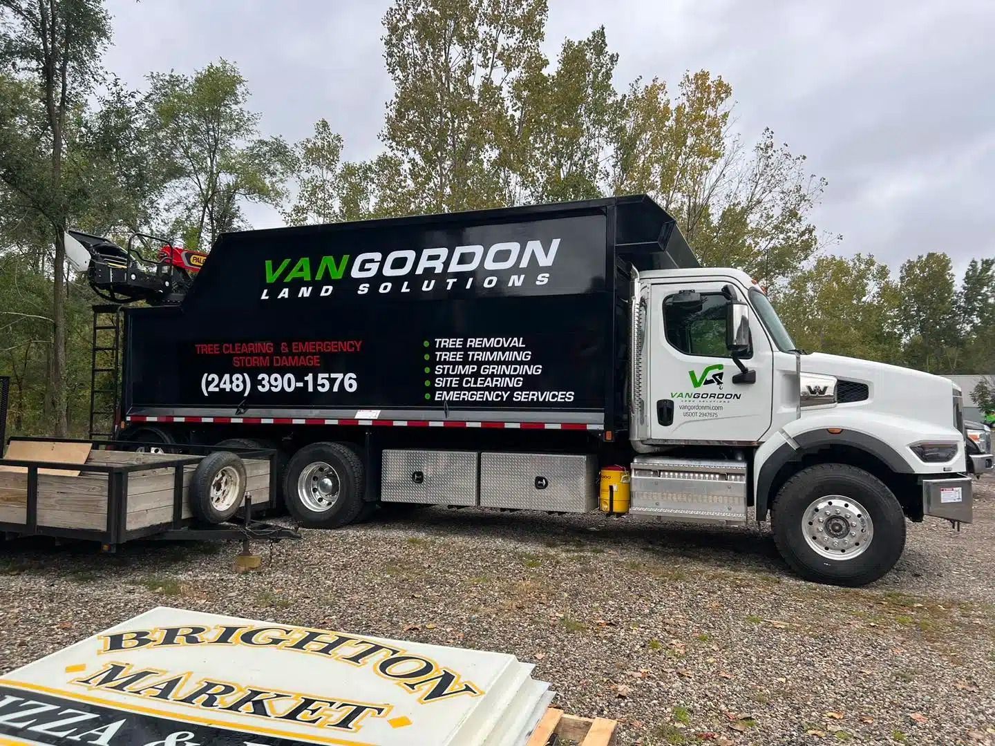 White truck with black dumpster bed, 