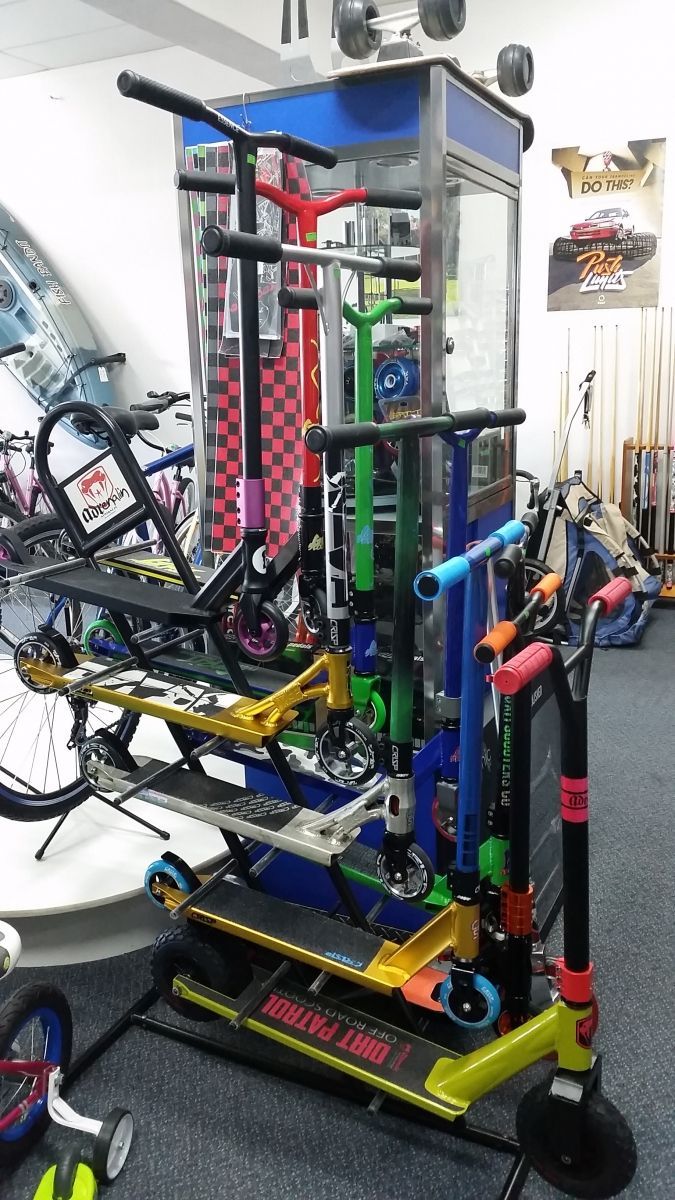 A Small, Vibrant BMX Bike with Oversized Black Tires Against a Gray Background — Freedom Sports in Bundaberg Central, QLD