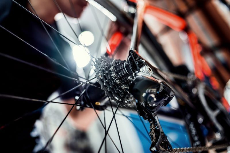 A Person is Working on a Bicycle With a Flashlight — Freedom Sports in Bundaberg Central, QLD