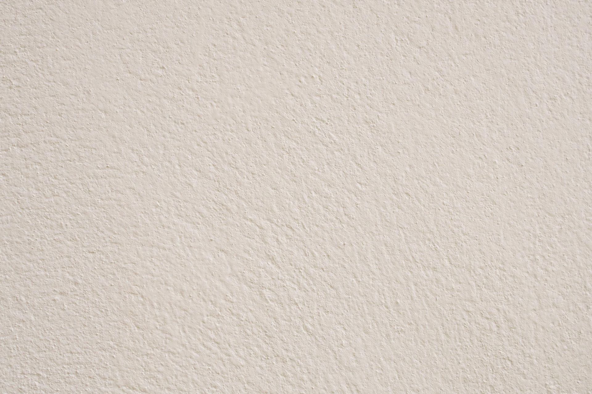 Close-up view of light beige textured wall.