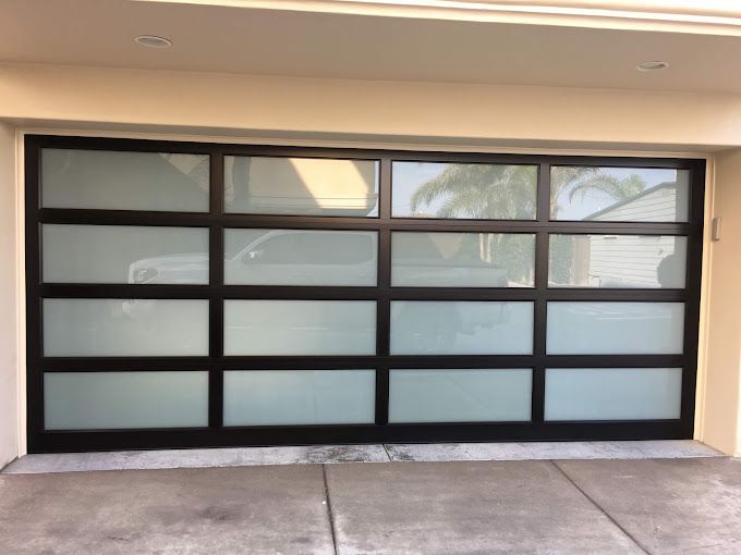 A black garage door with a lot of windows