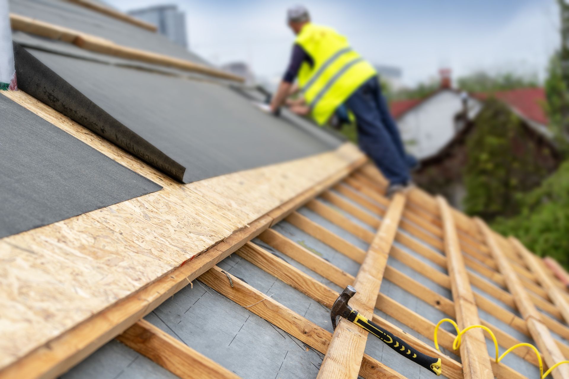 A man is working on the roof of a house.