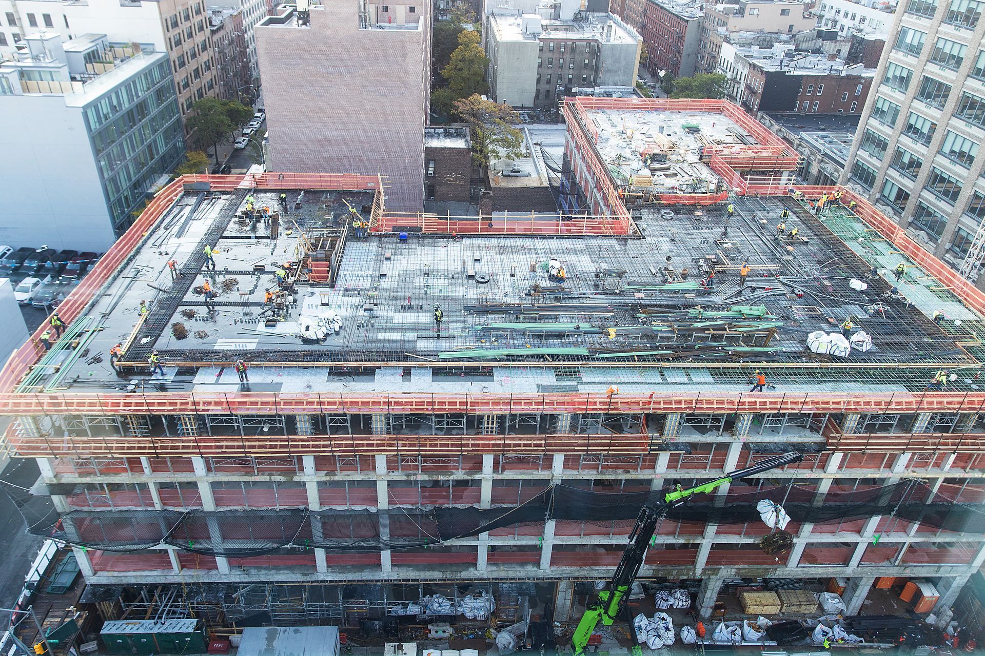 An aerial view of a building under construction in a city.
