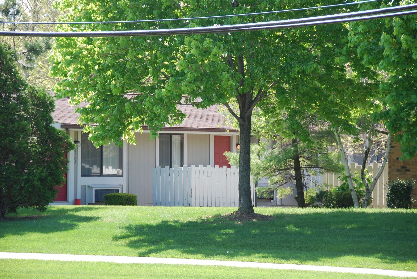 A house with a white picket fence and a red door