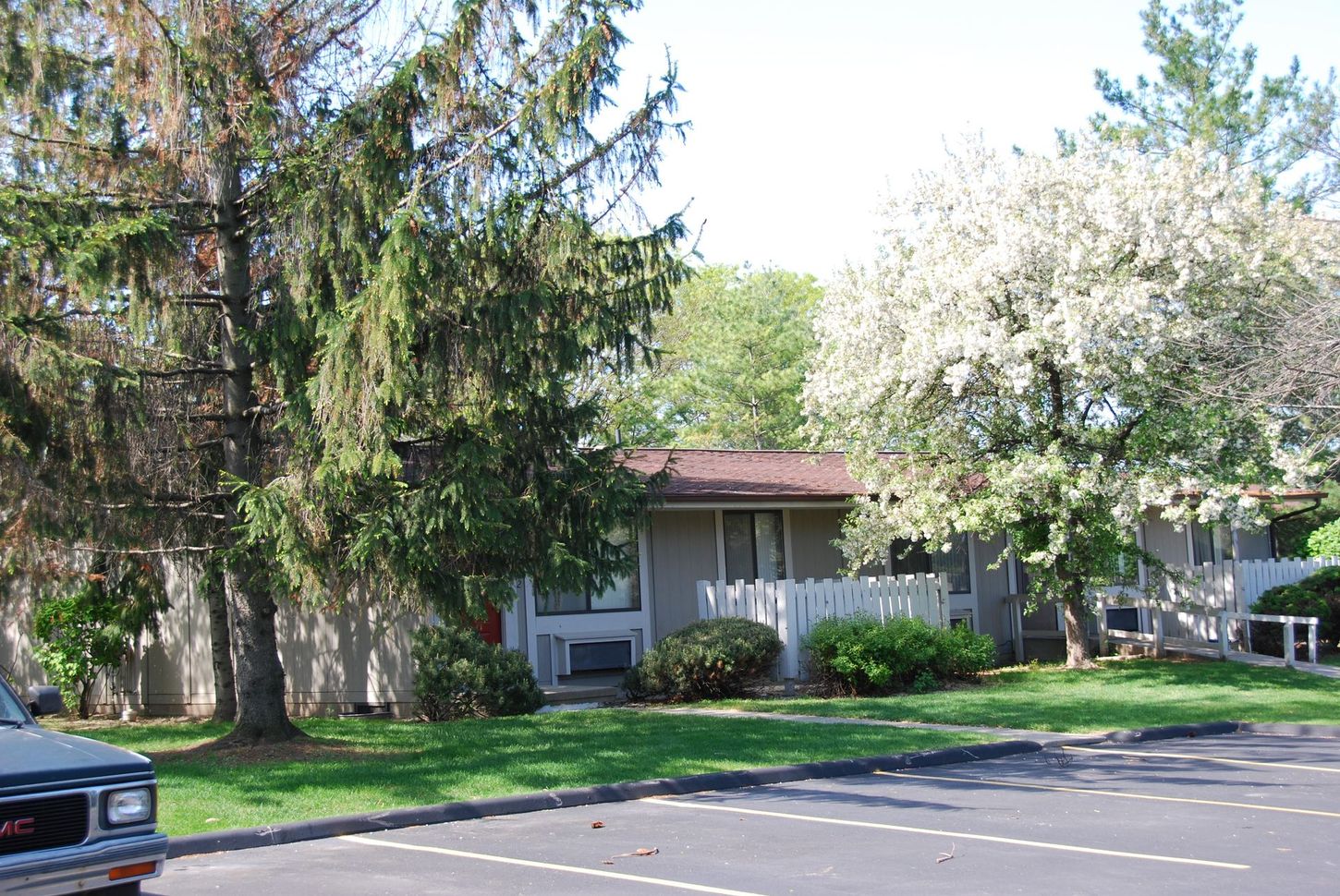 A gmc truck is parked in front of a house