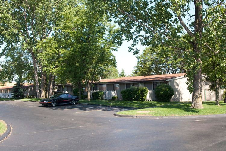 A black car is parked in front of a house